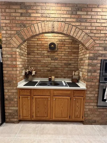 a stove top oven sitting inside of a kitchen