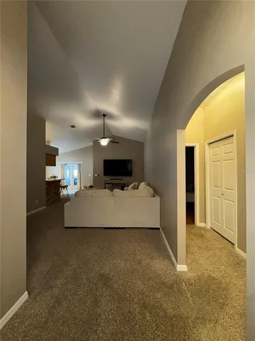 a large bedroom with a bed and a chandelier