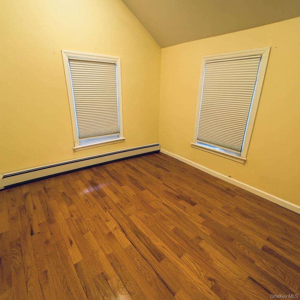 1243 Pea Pond Road North Bellmore, NY 11710 - Photo 12 of 16 an empty room with wooden floor and windows