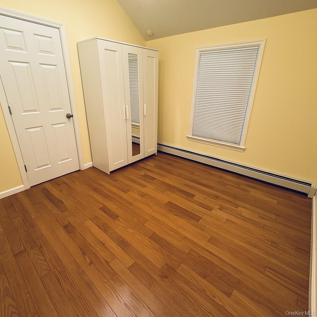 1243 Pea Pond Road North Bellmore, NY 11710 - Photo 13 of 16 an empty room with wooden floor and closet