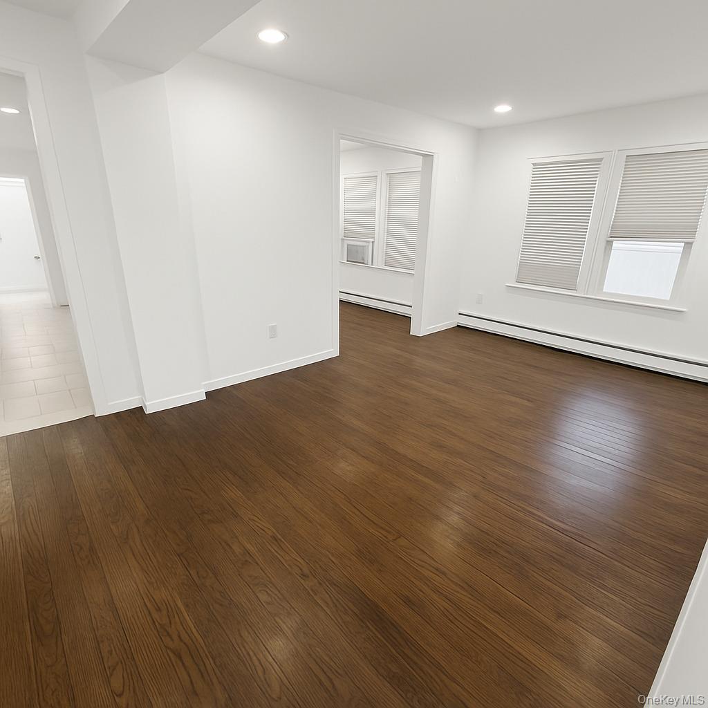1243 Pea Pond Road North Bellmore, NY 11710 - Photo 6 of 16 an empty room with wooden floor and white walls