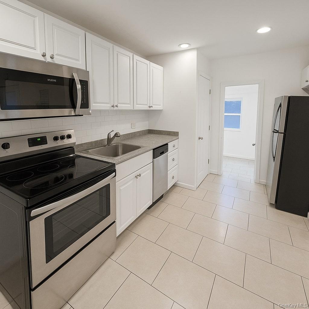 1243 Pea Pond Road North Bellmore, NY 11710 - Photo 8 of 16 a kitchen with granite countertop a stove and a microwave