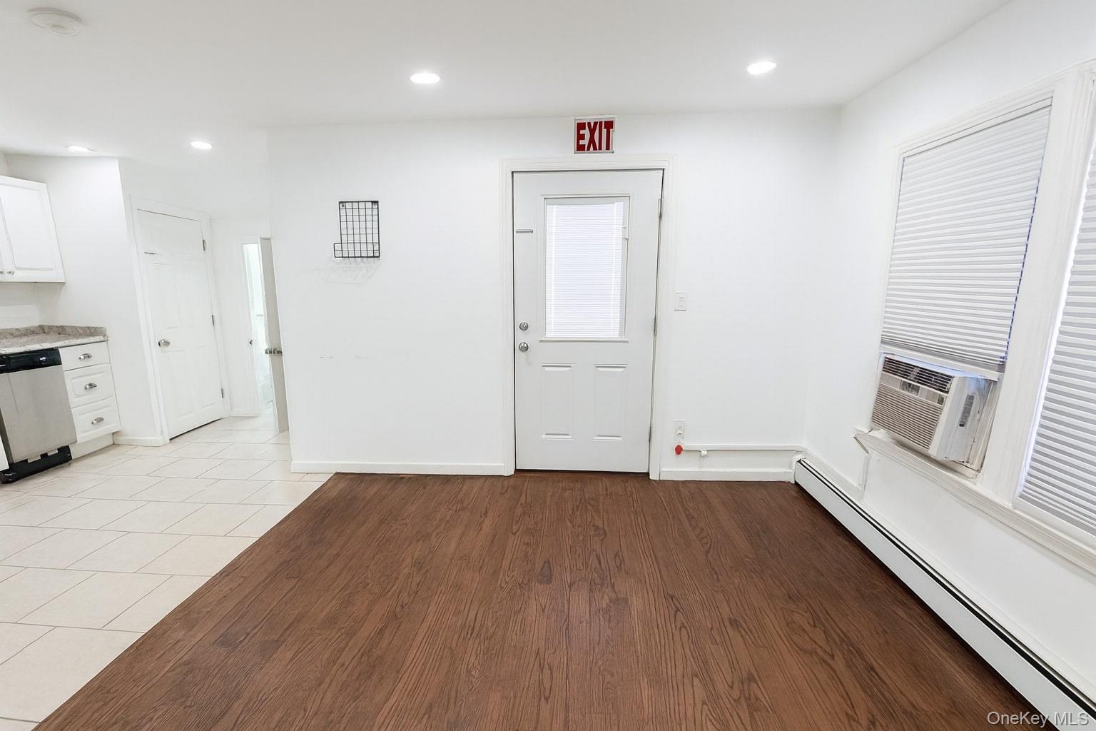 1243 Pea Pond Road North Bellmore, NY 11710 - Photo 10 of 16 an empty room with wooden floor and windows