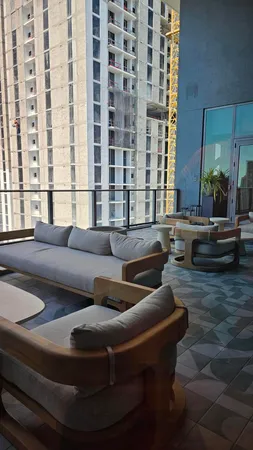 a living room with furniture and a floor to ceiling window