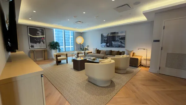 a living room with furniture a flat screen tv and a large window