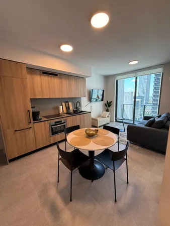a kitchen with a table chairs and a refrigerator