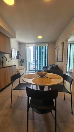 a spacious bedroom with a bed a table and chair