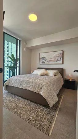a bedroom with a bed and window
