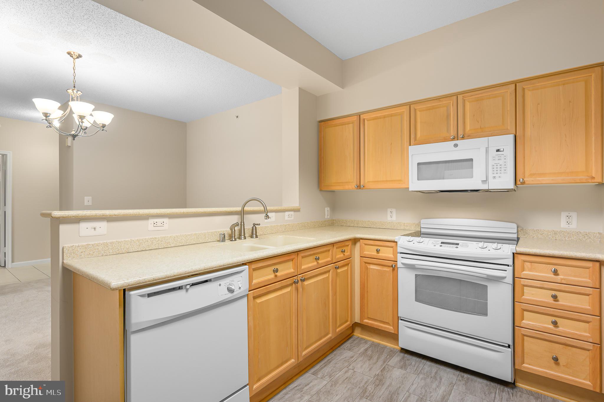 19355 Cypress Ridge Terrace, Unit 404 Leesburg, VA 20176 - Photo 10 of 39 a kitchen with a sink stove and cabinets