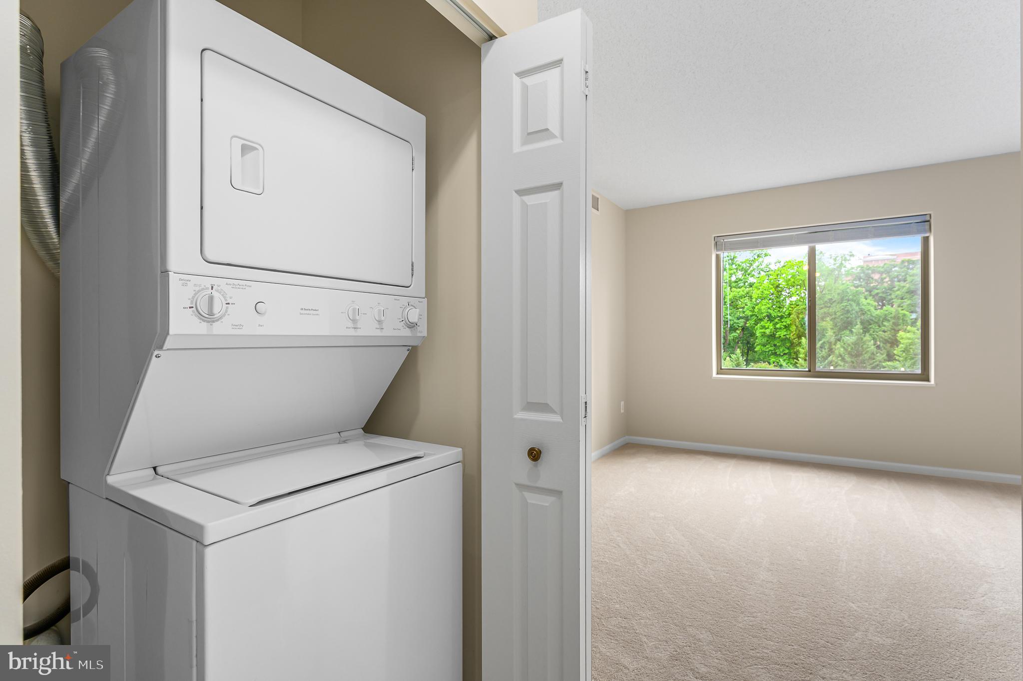 19355 Cypress Ridge Terrace, Unit 404 Leesburg, VA 20176 - Photo 15 of 39 a view of washer and dryer with bathroom in the background