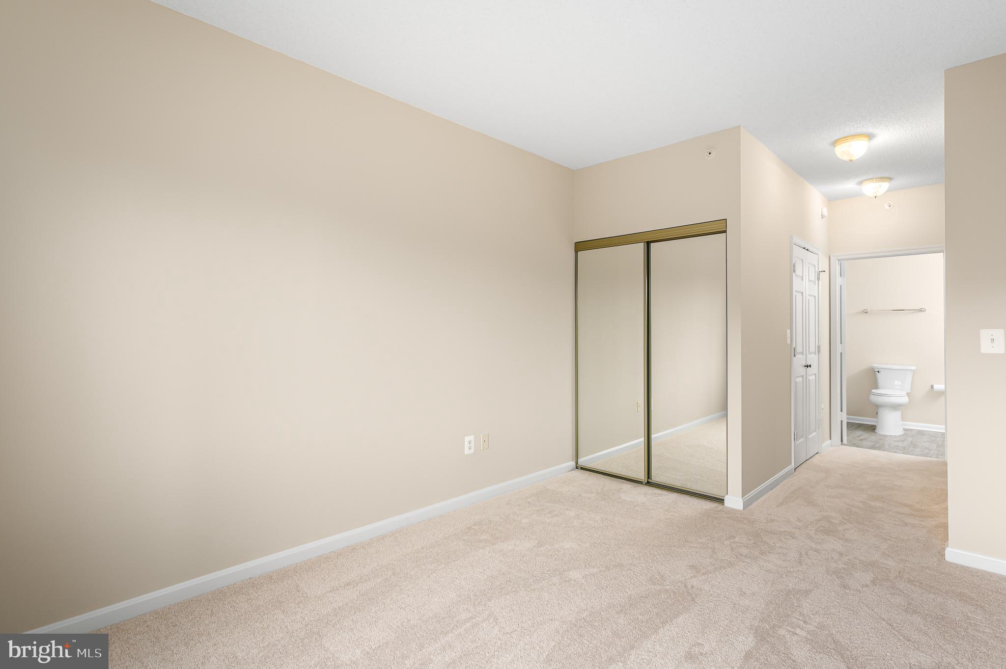 19355 Cypress Ridge Terrace, Unit 404 Leesburg, VA 20176 - Photo 16 of 39 an empty room with large glass door