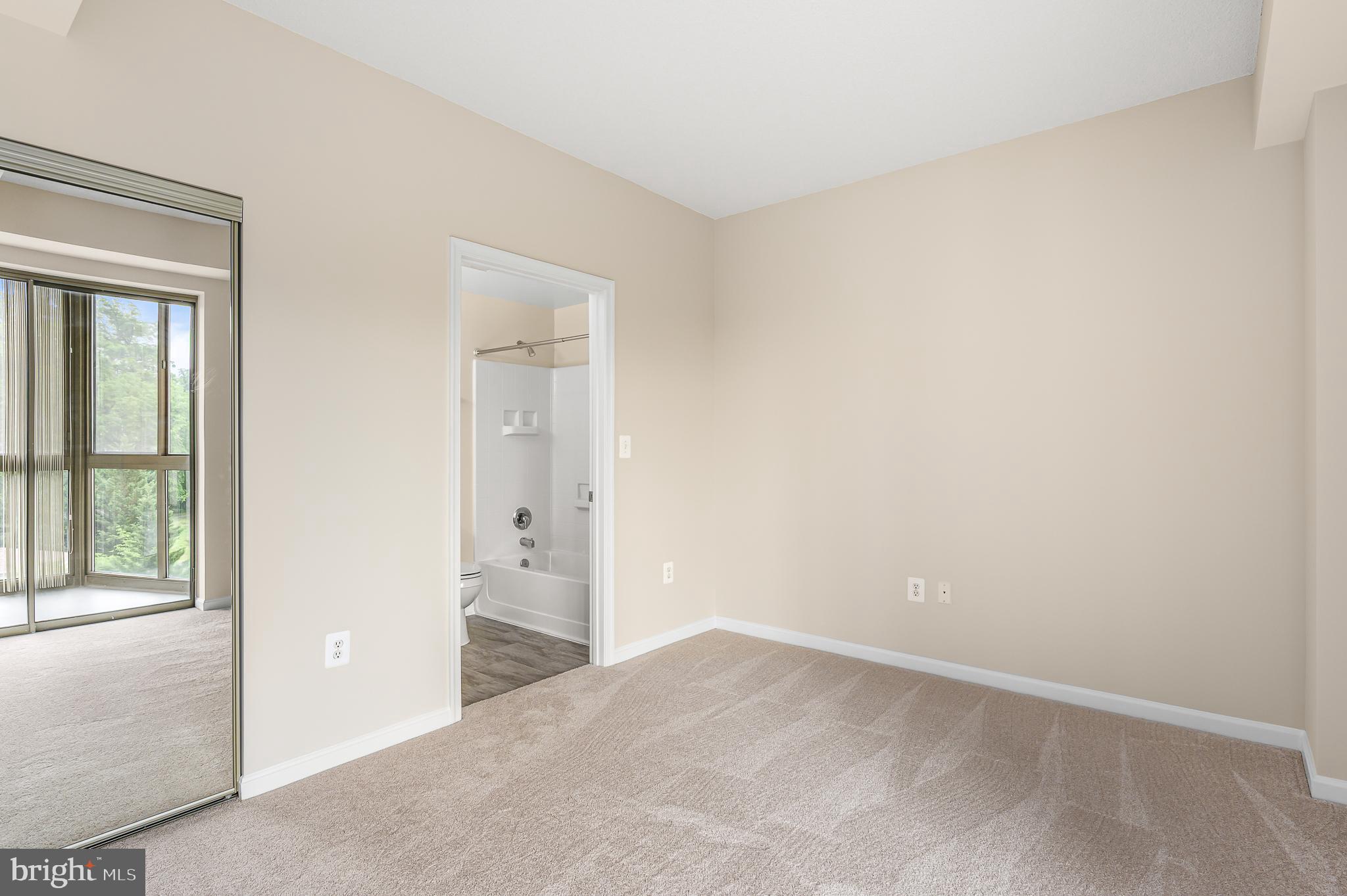 19355 Cypress Ridge Terrace, Unit 404 Leesburg, VA 20176 - Photo 19 of 39 an empty room with windows and closet