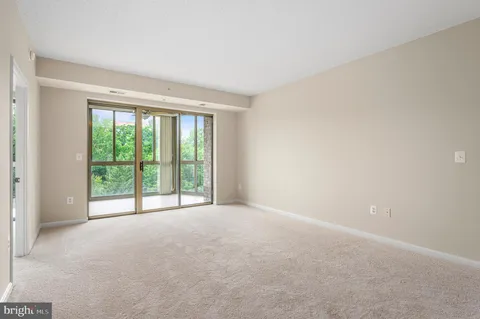 a view of a hallway with furniture and a window