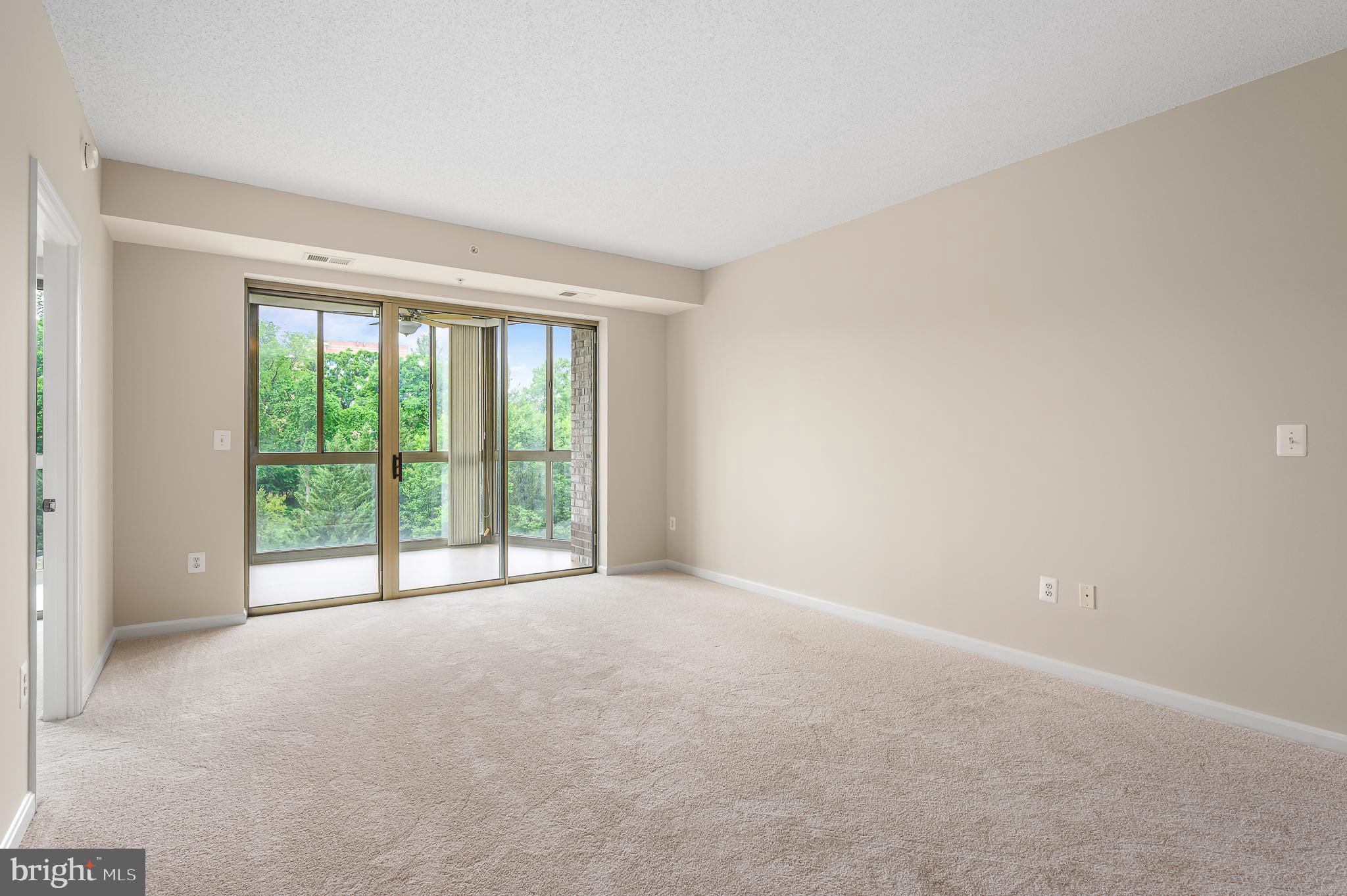 19355 Cypress Ridge Terrace, Unit 404 Leesburg, VA 20176 - Photo 3 of 39 a view of an empty room with a large window