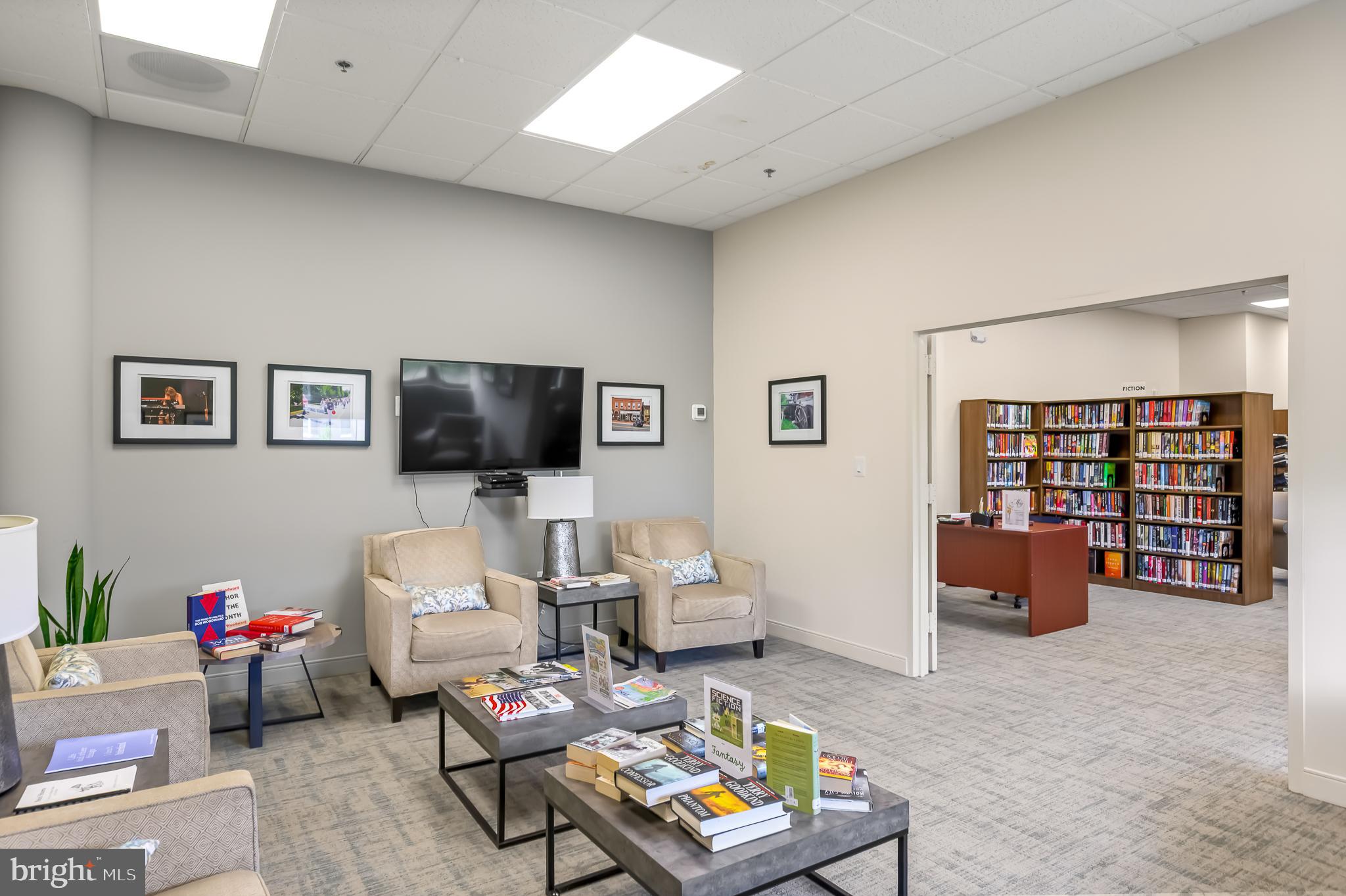 19355 Cypress Ridge Terrace, Unit 404 Leesburg, VA 20176 - Photo 35 of 39 a living room with furniture and a flat screen tv