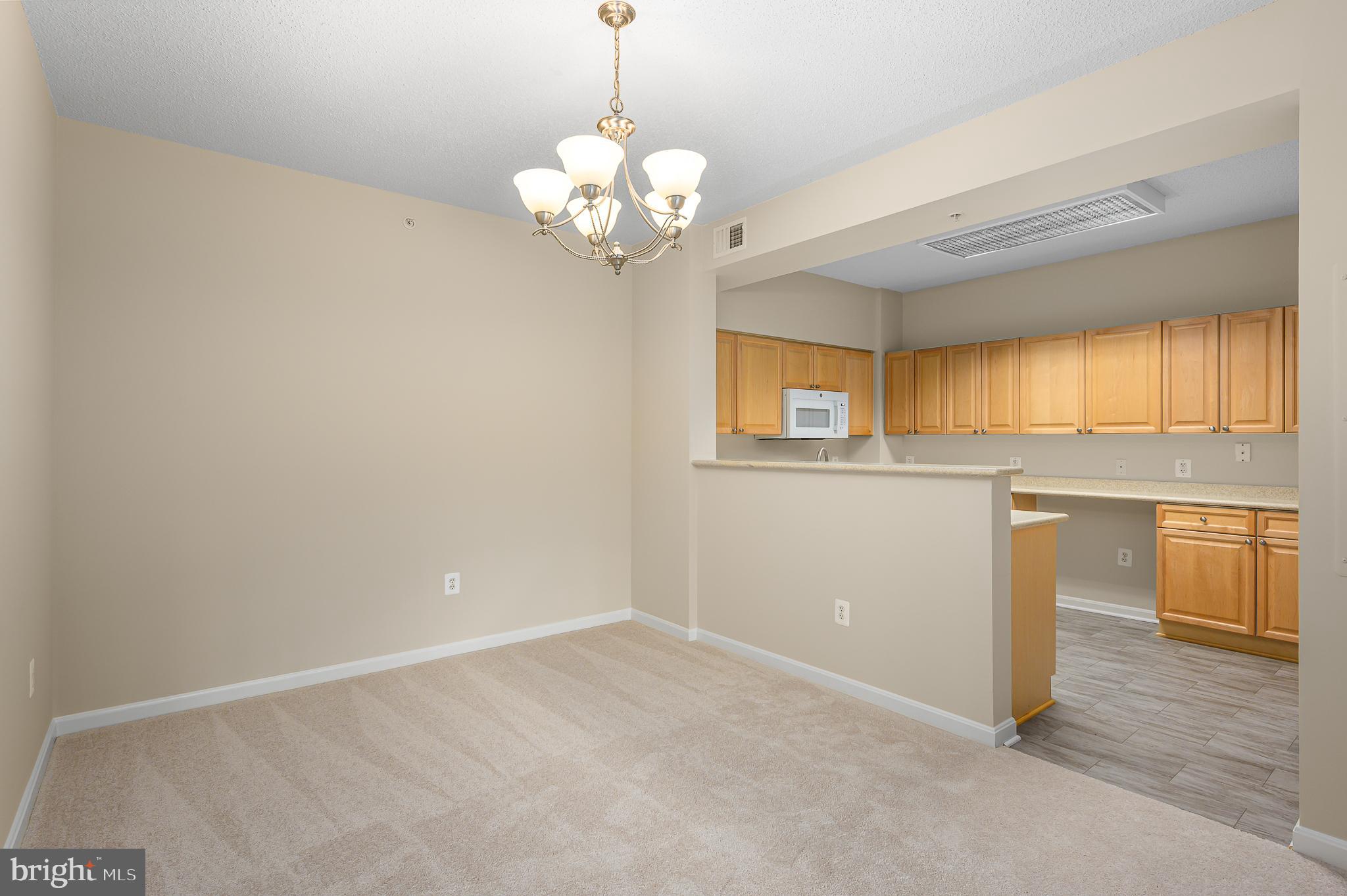 19355 Cypress Ridge Terrace, Unit 404 Leesburg, VA 20176 - Photo 8 of 39 a view of a kitchen with a sink cabinets and wooden floor