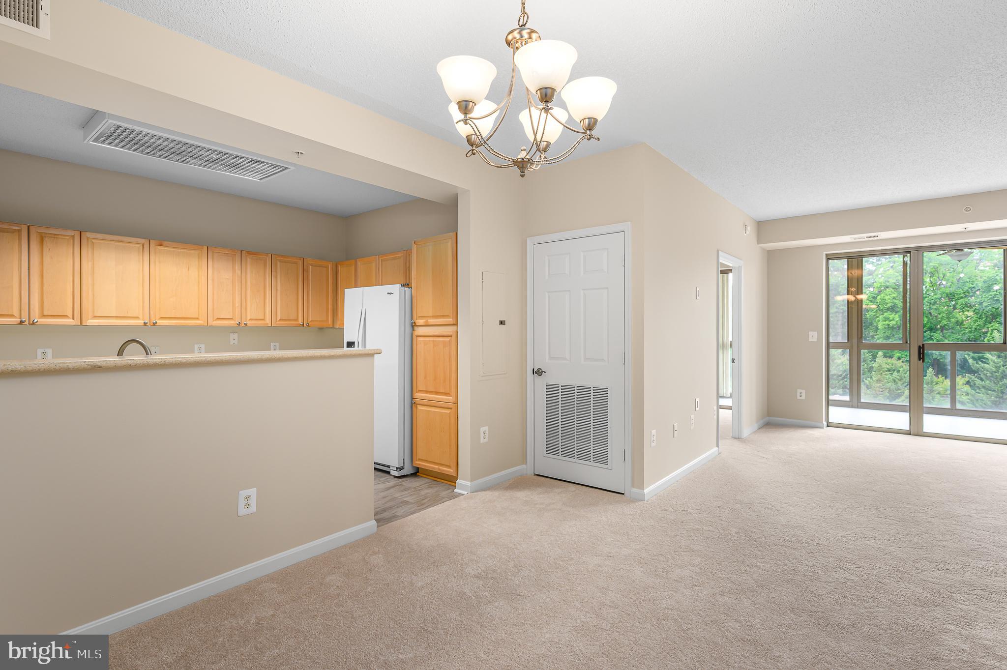 19355 Cypress Ridge Terrace, Unit 404 Leesburg, VA 20176 - Photo 39 of 39 a view of a livingroom with a chandelier fan and windows