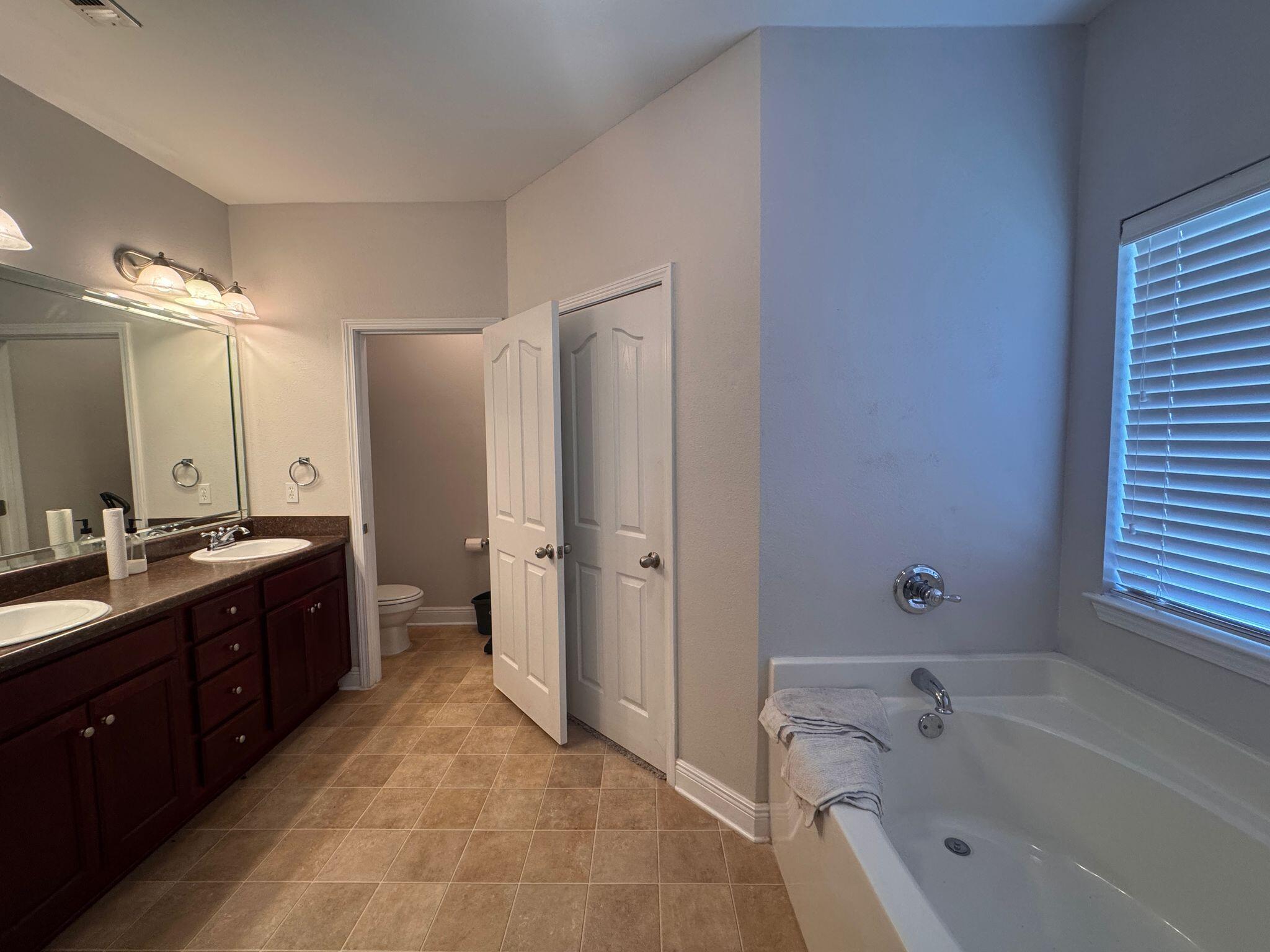 744 Lime Lane Crestview, FL 32536 - Photo 16 of 25 a spacious bathroom with a tub sink shower and mirror