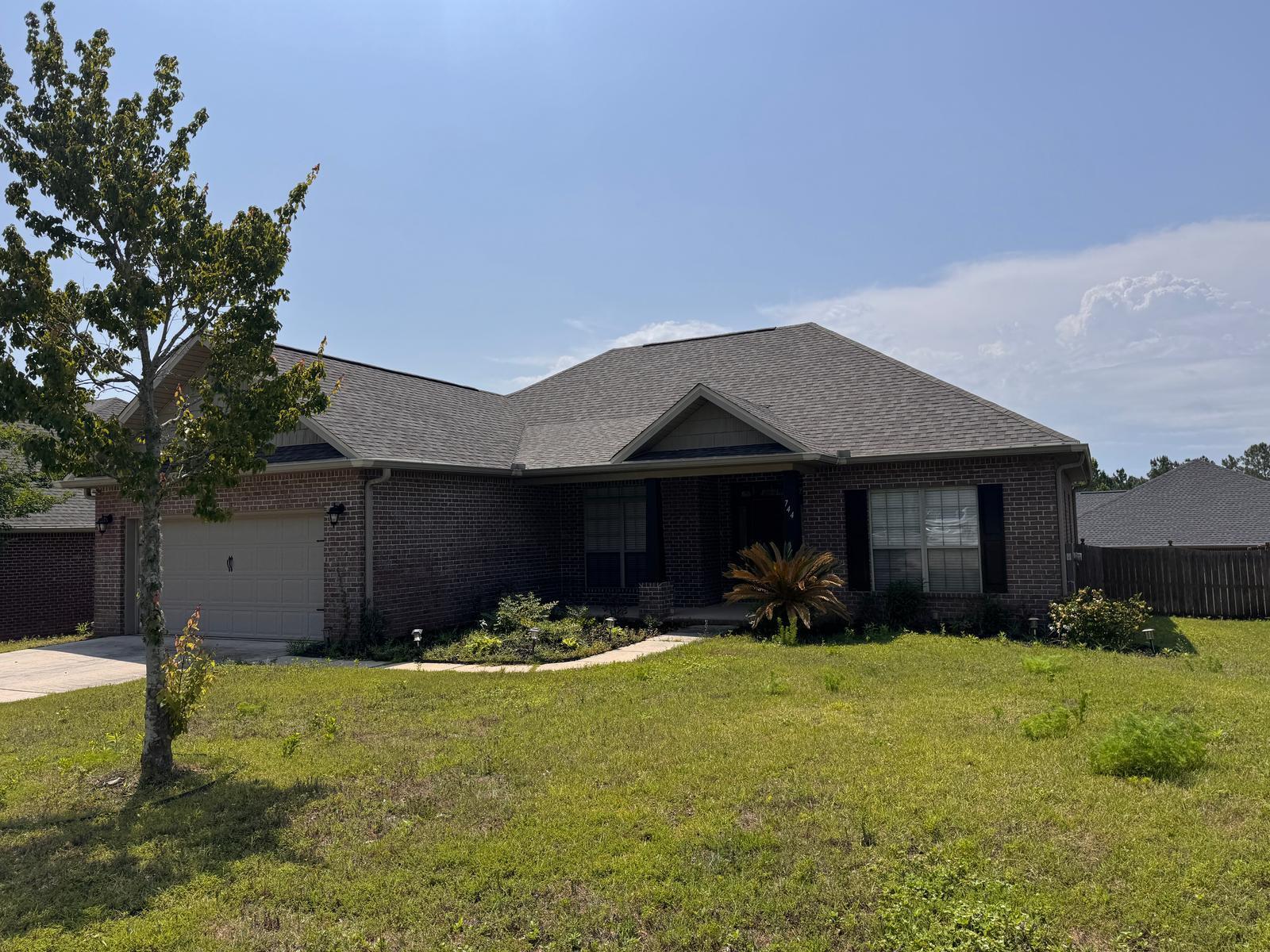 744 Lime Lane Crestview, FL 32536 - Photo 2 of 25 a front view of a house with patio yard and outdoor seating