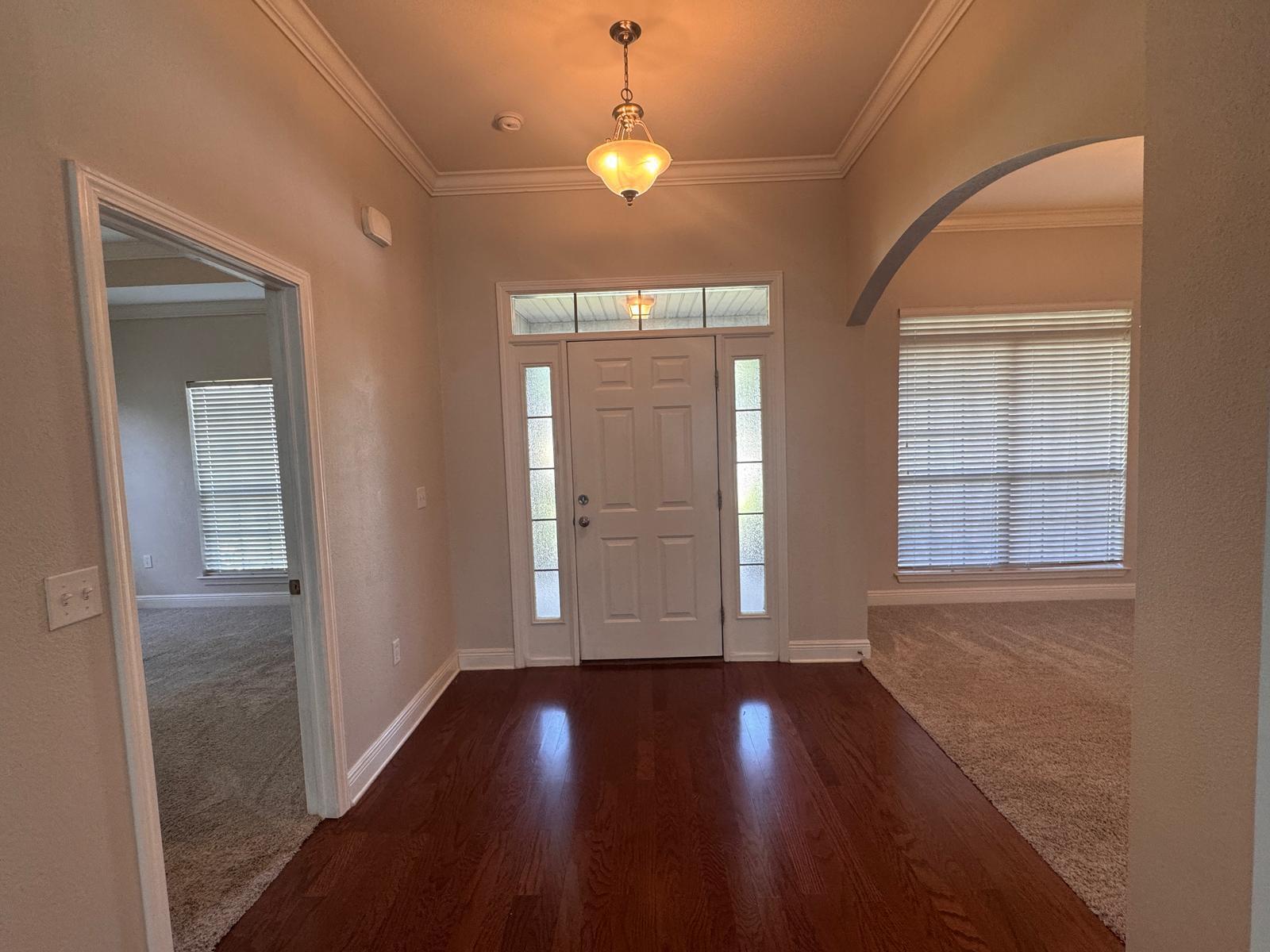 744 Lime Lane Crestview, FL 32536 - Photo 4 of 25 an empty room with wooden floor and windows