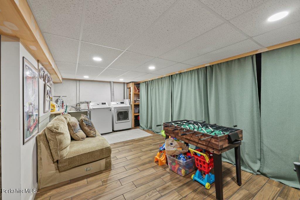 33 Eleanor Road Pittsfield, MA 01201 - Photo 40 of 45 a living room with furniture a table and gym equipment