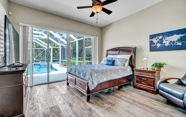 a bedroom with a bed and a potted plant