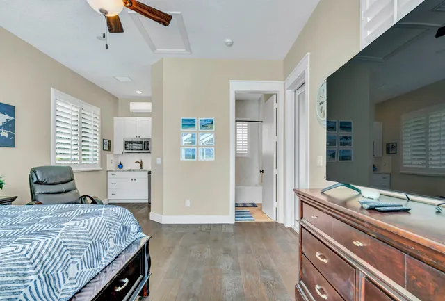 a bedroom with a bed and a chandelier