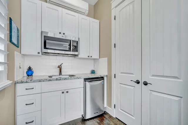 a bathroom with a granite countertop sink a toilet and shower