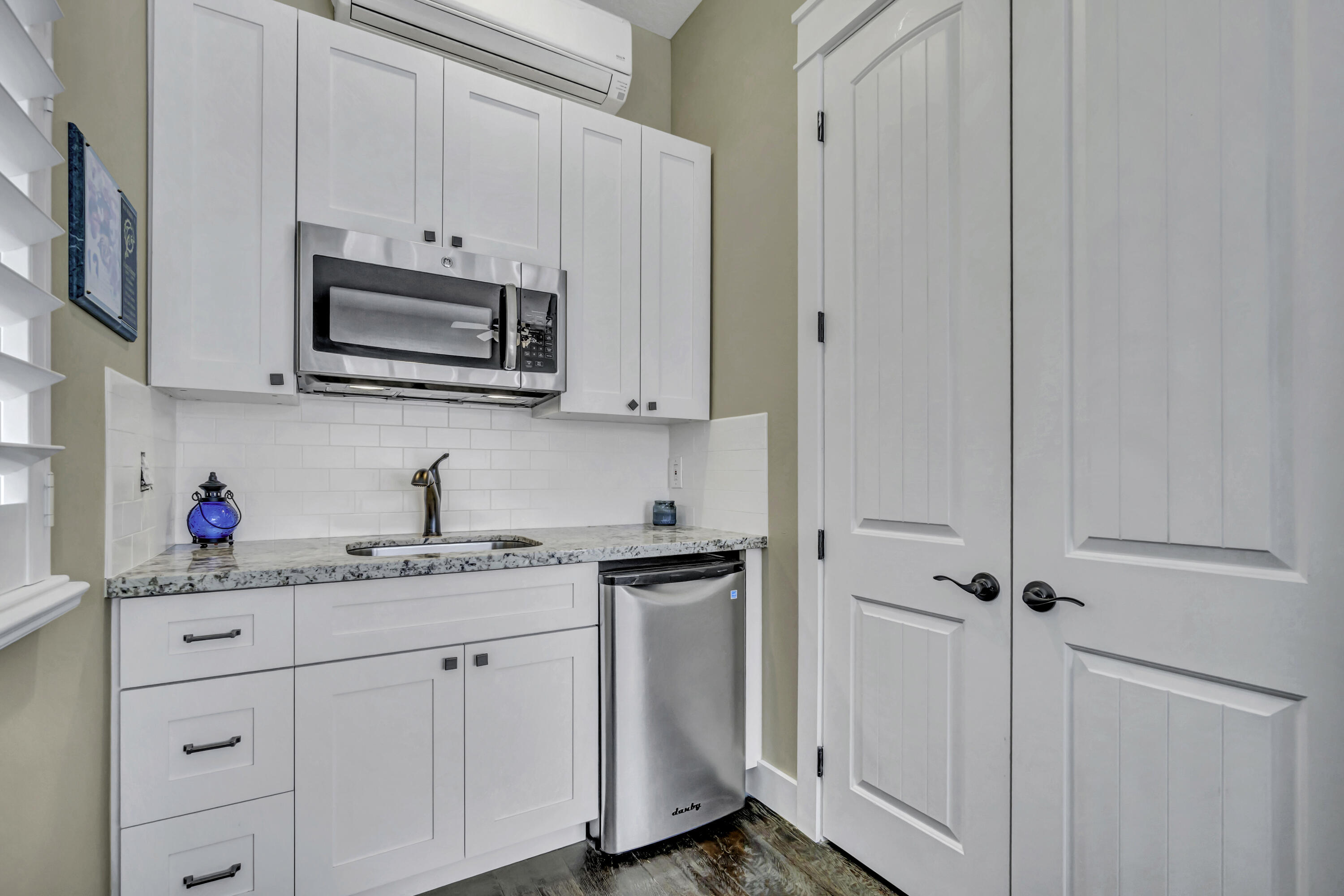 1209 Breakers W Boulevard West Palm Beach, FL 33411 - Photo 16 of 73 a kitchen with stainless steel appliances white cabinets and a sink