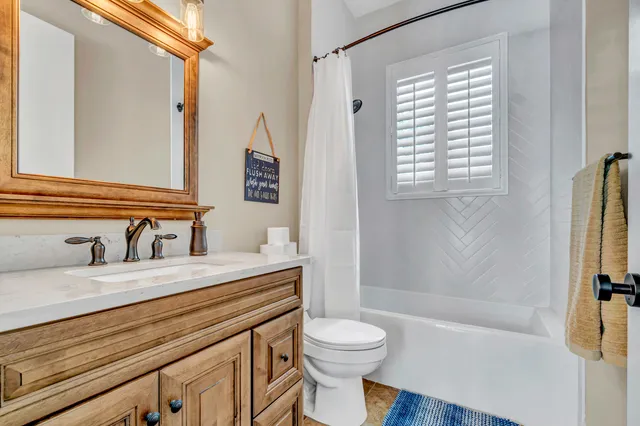 a bathroom with a toilet a sink and shower