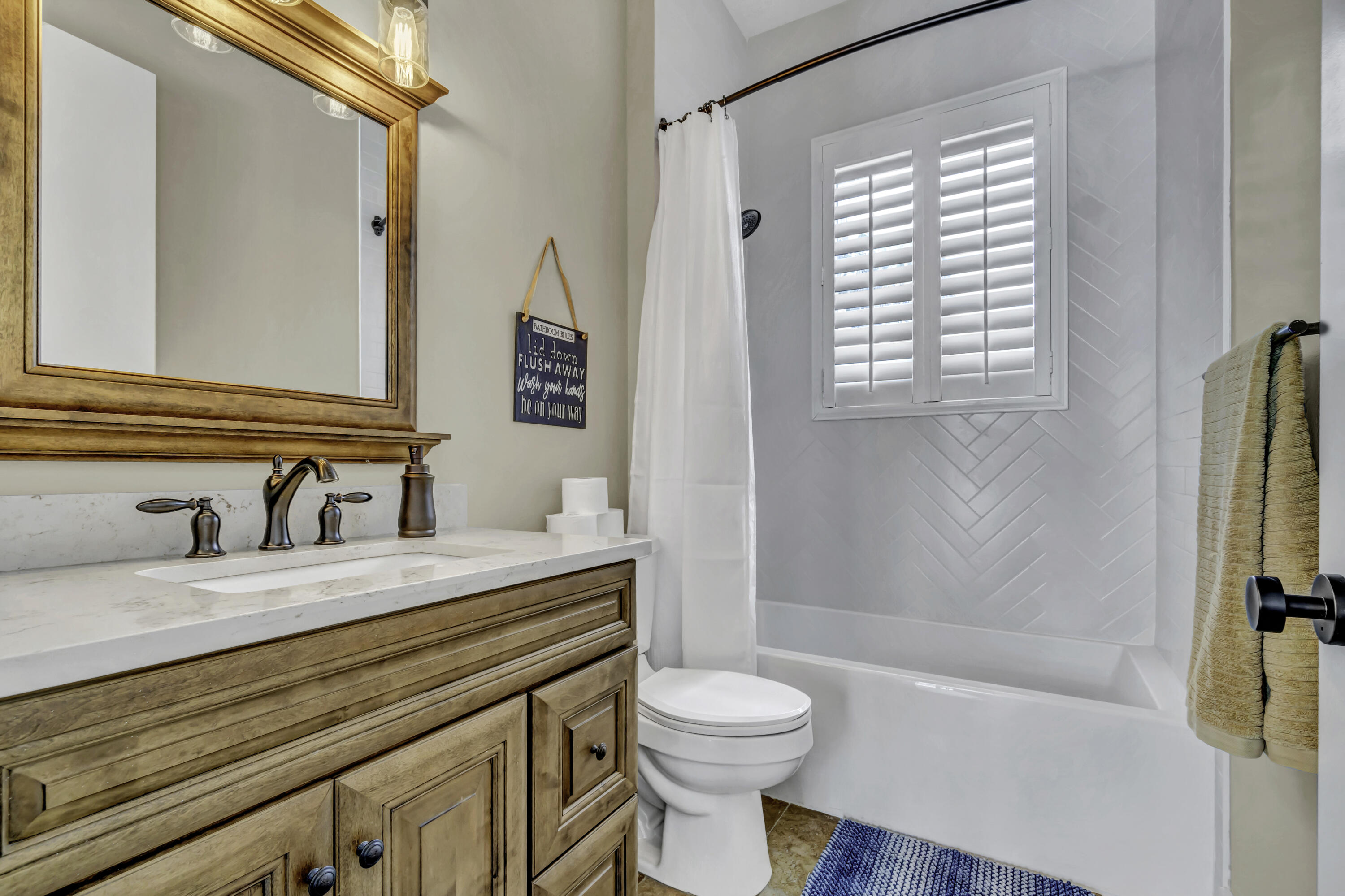 1209 Breakers W Boulevard West Palm Beach, FL 33411 - Photo 17 of 73 a bathroom with a granite countertop sink toilet and shower