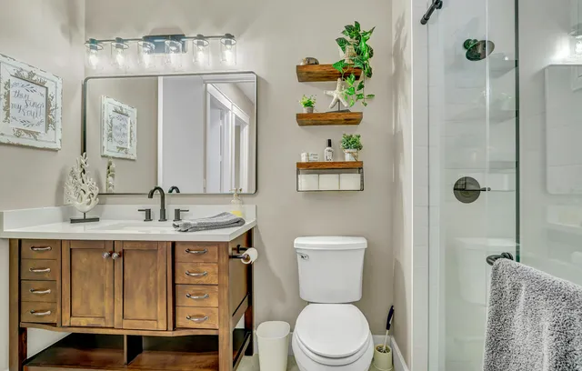 a utility room with refrigerator and mirror