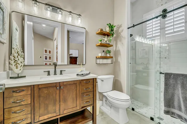 a kitchen with stainless steel appliances granite countertop a sink a stove top oven a counter space and cabinets