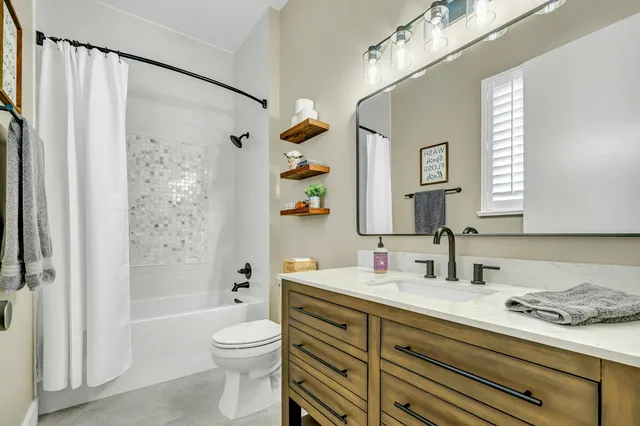 a kitchen with stainless steel appliances a dining table chairs and chandelier