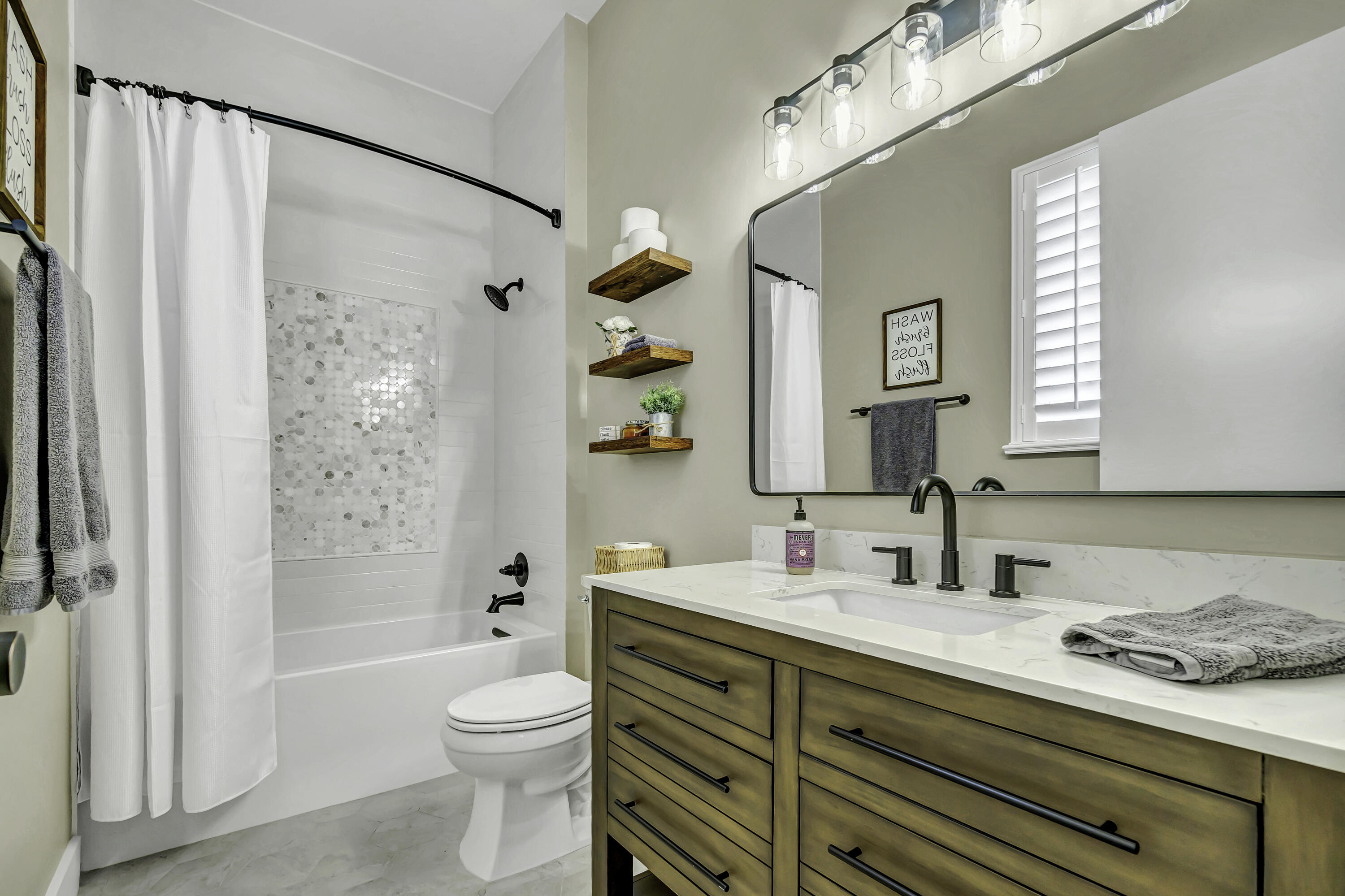 1209 Breakers W Boulevard West Palm Beach, FL 33411 - Photo 23 of 73 a bathroom with a granite countertop sink toilet and shower