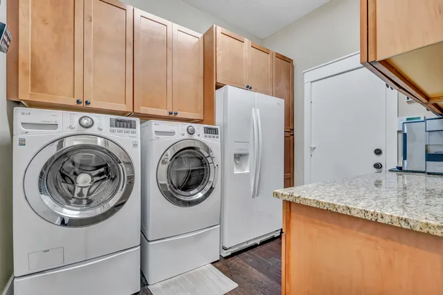 a kitchen with stainless steel appliances granite countertop a refrigerator and cabinets