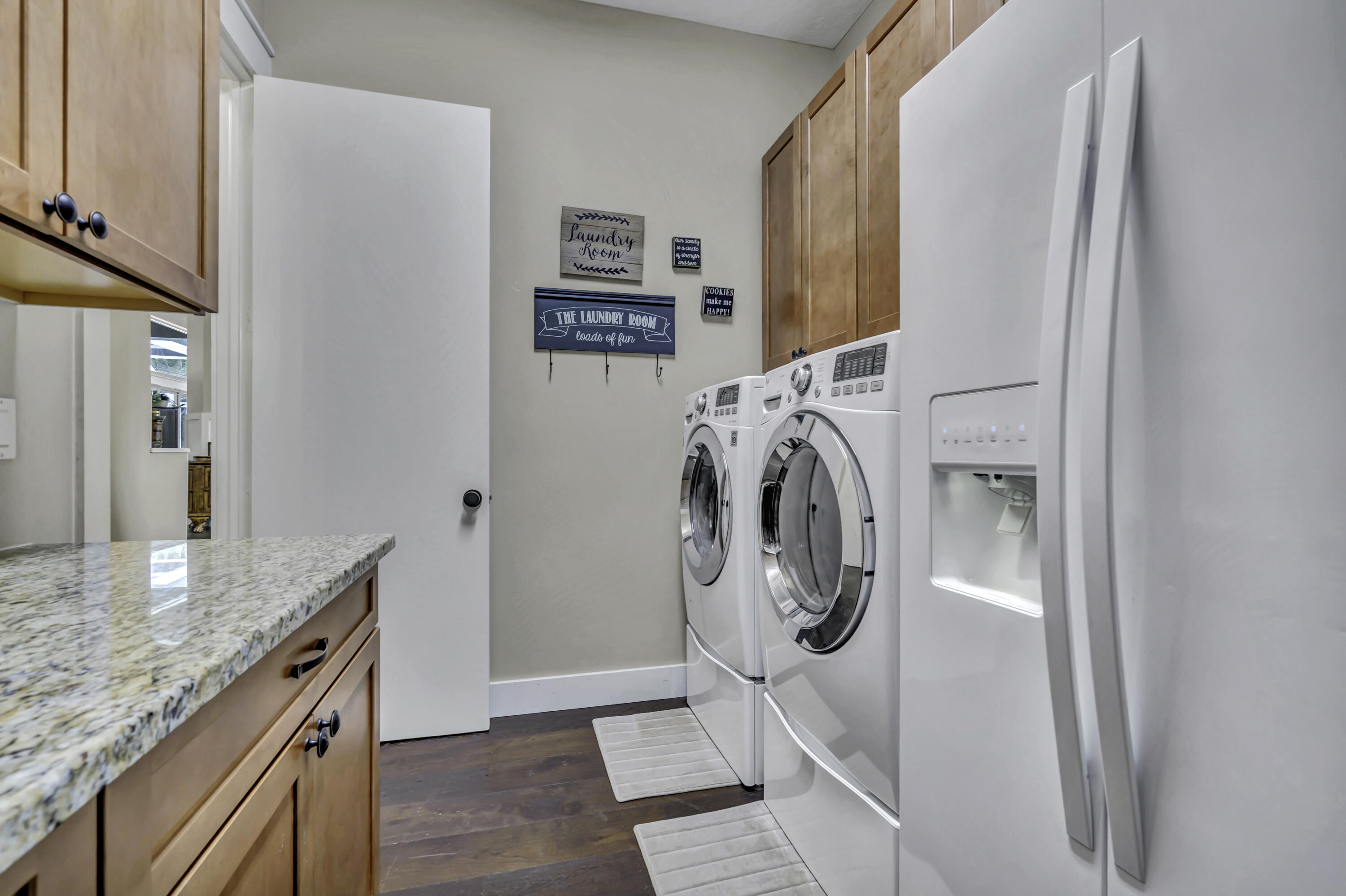 1209 Breakers W Boulevard West Palm Beach, FL 33411 - Photo 25 of 73 a utility room with refrigerator and mirror