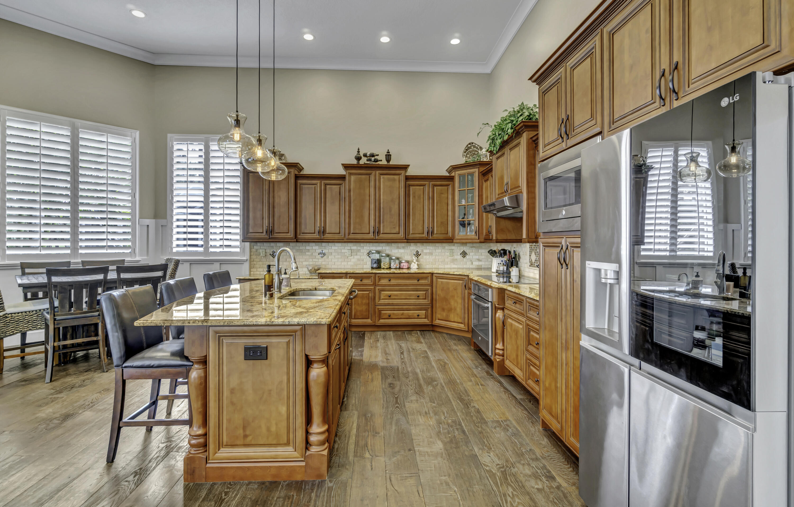 1209 Breakers W Boulevard West Palm Beach, FL 33411 - Photo 26 of 73 a kitchen with stainless steel appliances granite countertop a sink a stove top oven a counter space and cabinets