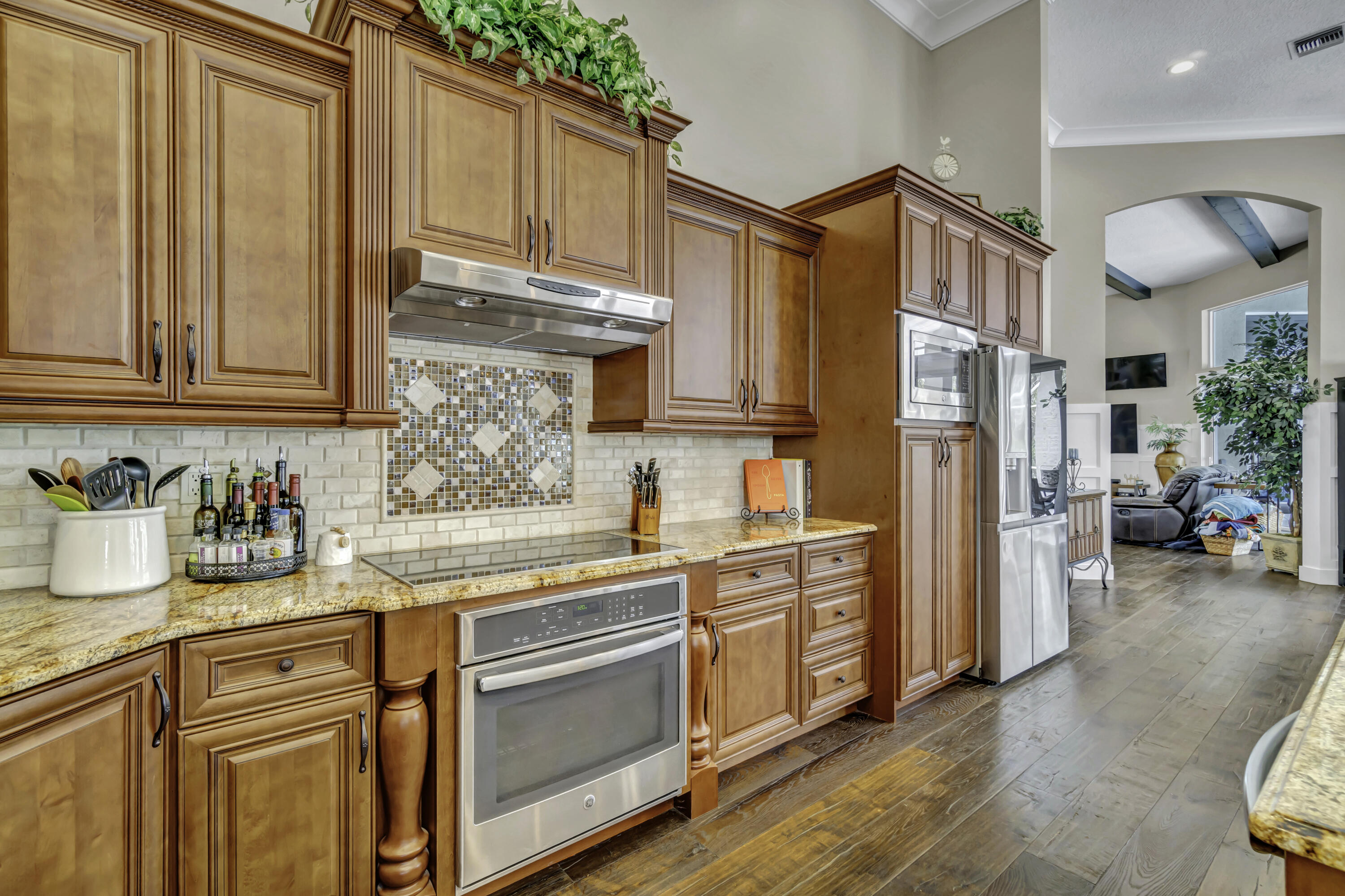 1209 Breakers W Boulevard West Palm Beach, FL 33411 - Photo 30 of 73 a kitchen with stainless steel appliances granite countertop a refrigerator and cabinets