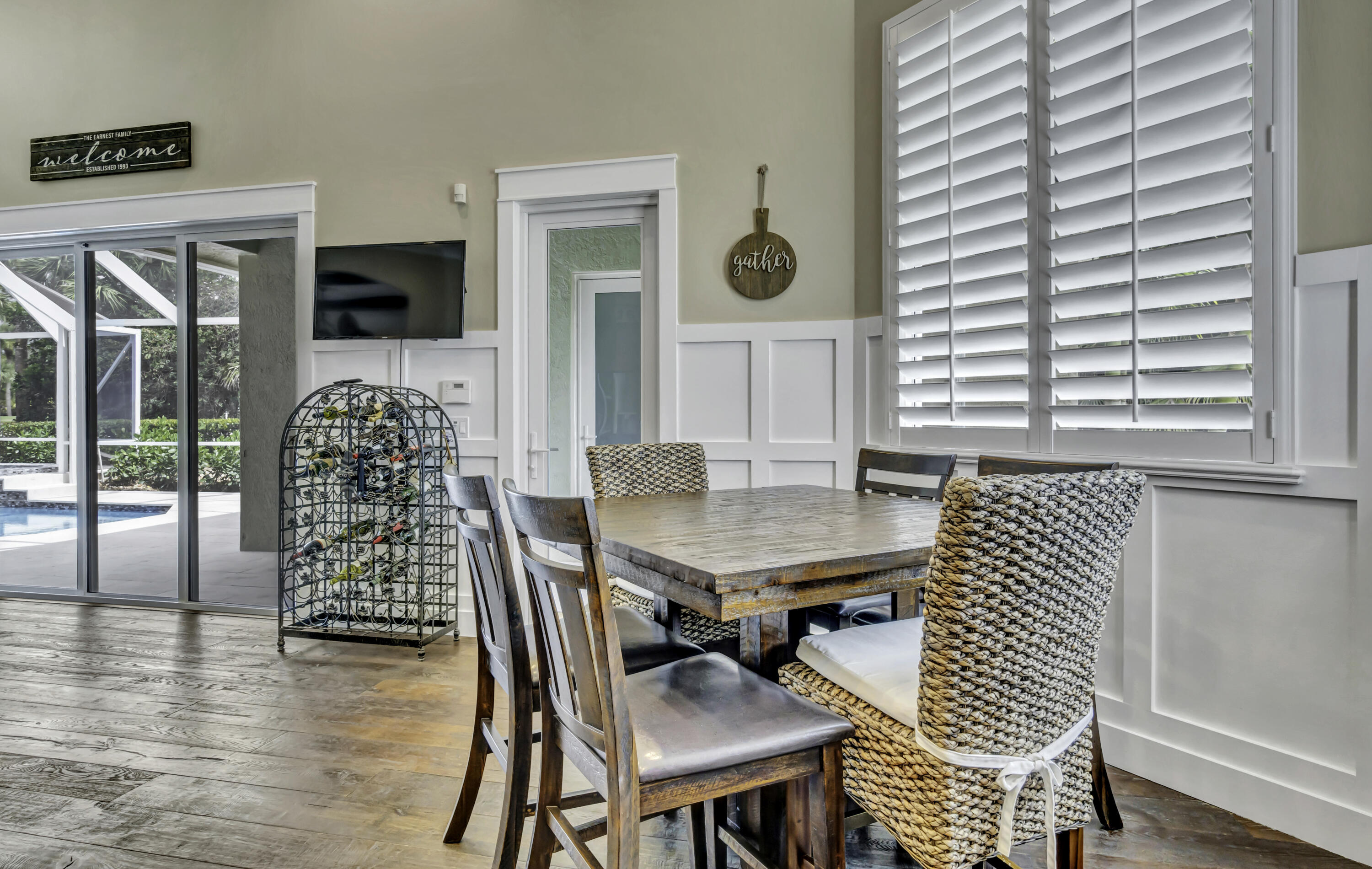 1209 Breakers W Boulevard West Palm Beach, FL 33411 - Photo 31 of 73 a view of a dining room with furniture and wooden floor