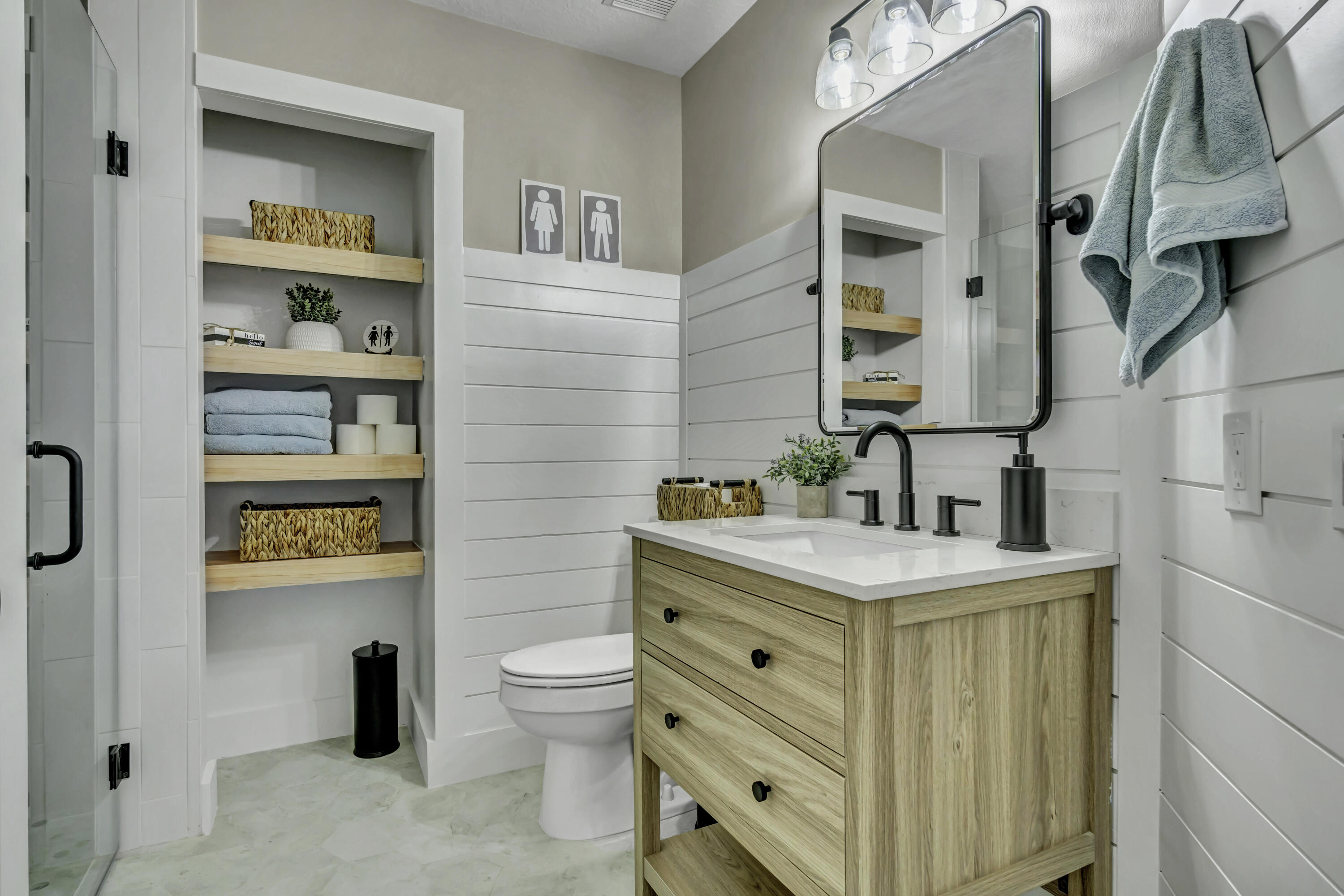 1209 Breakers W Boulevard West Palm Beach, FL 33411 - Photo 36 of 73 a bathroom with a sink a toilet and a mirror