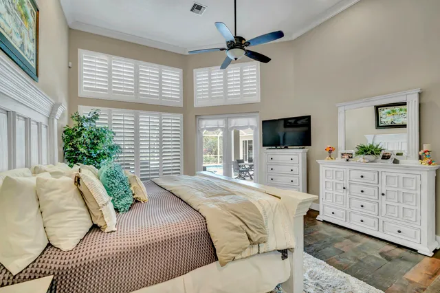 a view of a patio with couple of chairs and a potted plant