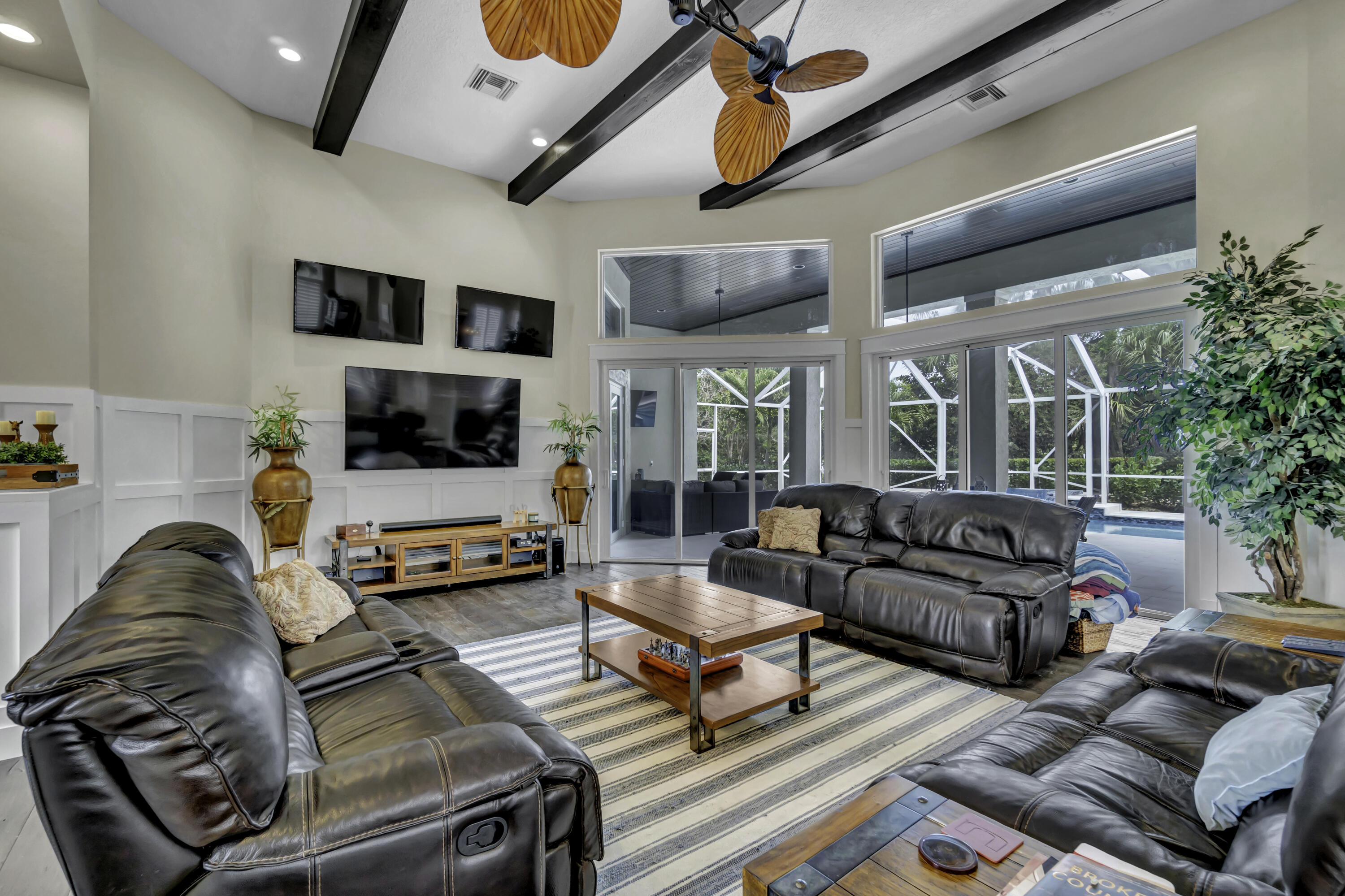 1209 Breakers W Boulevard West Palm Beach, FL 33411 - Photo 50 of 73 a living room with furniture and a flat screen tv