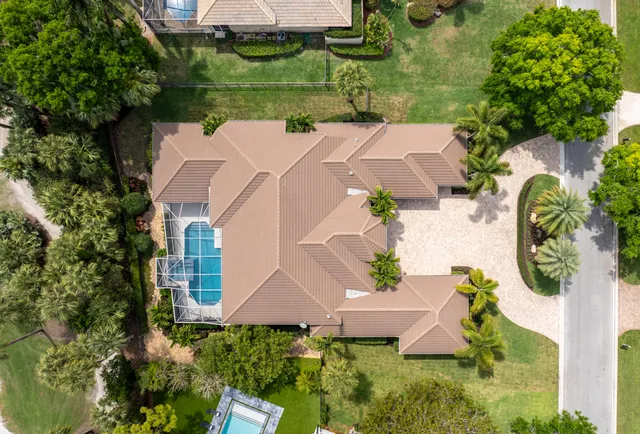 an aerial view of residential houses with outdoor space and river