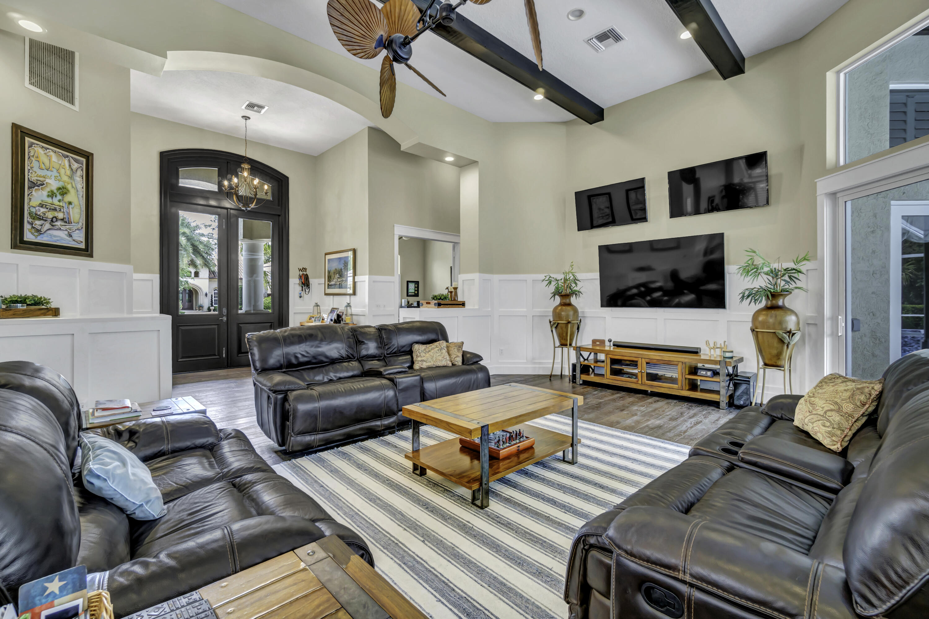 1209 Breakers W Boulevard West Palm Beach, FL 33411 - Photo 52 of 73 a living room with furniture and a flat screen tv