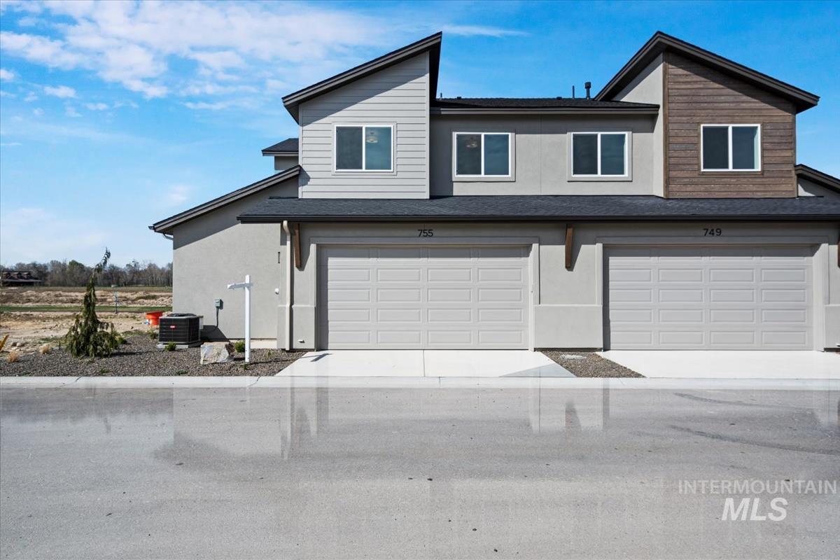 749 South Calhoun Lane Star, ID 83669 - Photo 32 of 34 View of front of home with an attached garage, stucco siding, and driveway