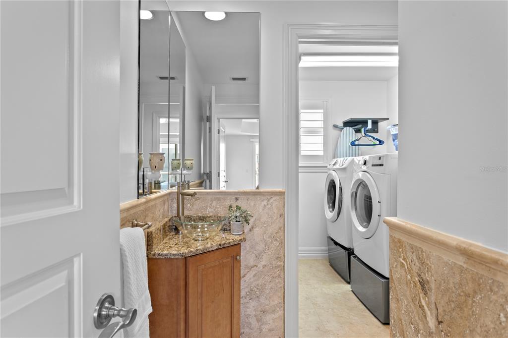 19730 Gulf Boulevard, Unit 400 Indian Rocks Beach, FL 33785 - Photo 51 of 90 a bathroom with a sink a washer and dryer