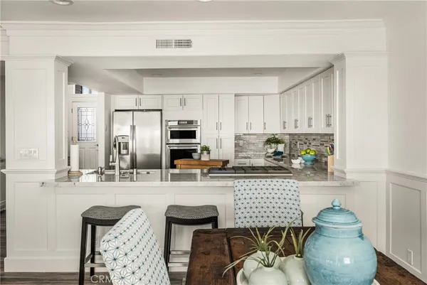 a living room with furniture a dining table and kitchen view