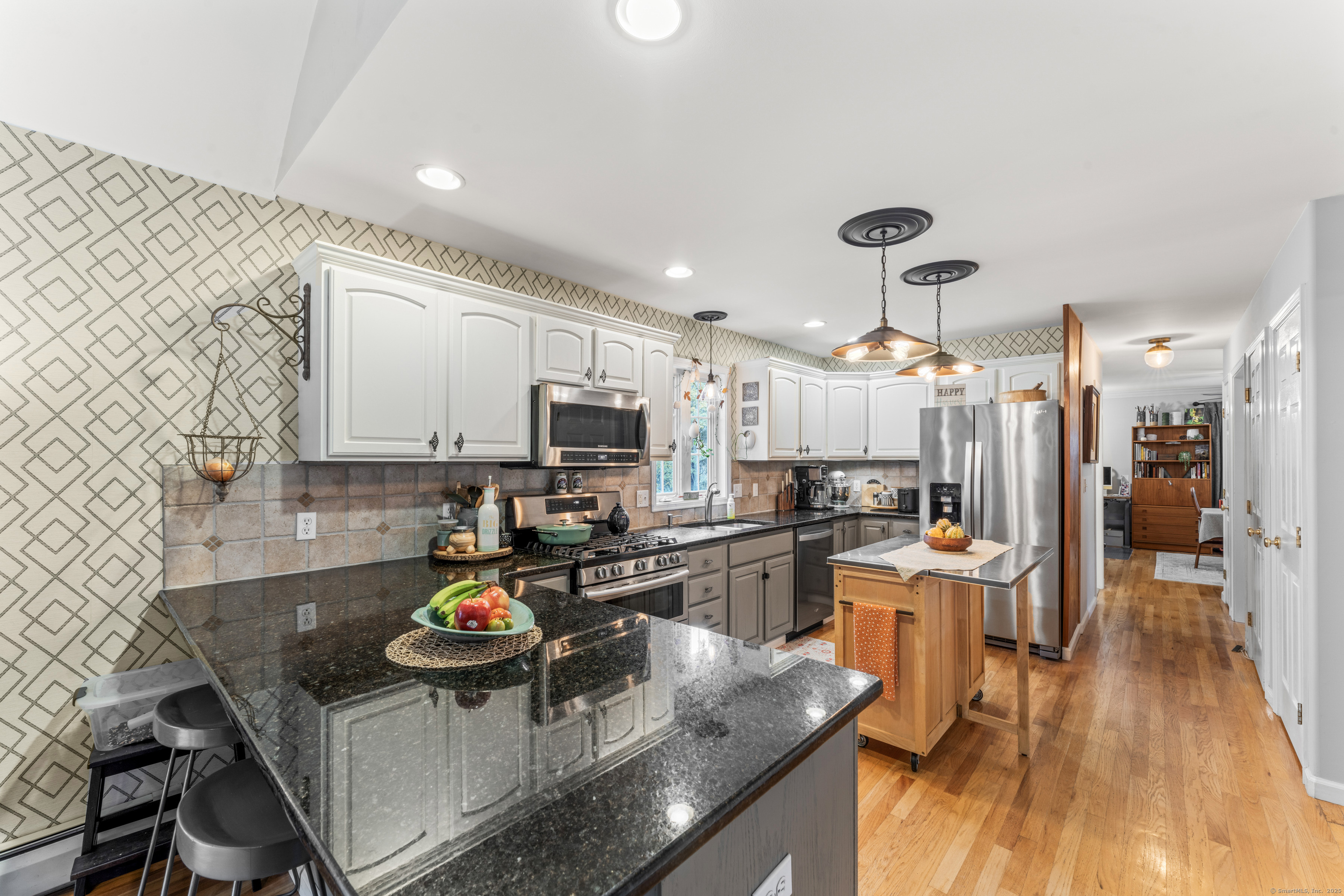 22 Lincoln Road Newtown, CT 06470 - Photo 14 of 36 a kitchen with stainless steel appliances kitchen island granite countertop a sink refrigerator and cabinets