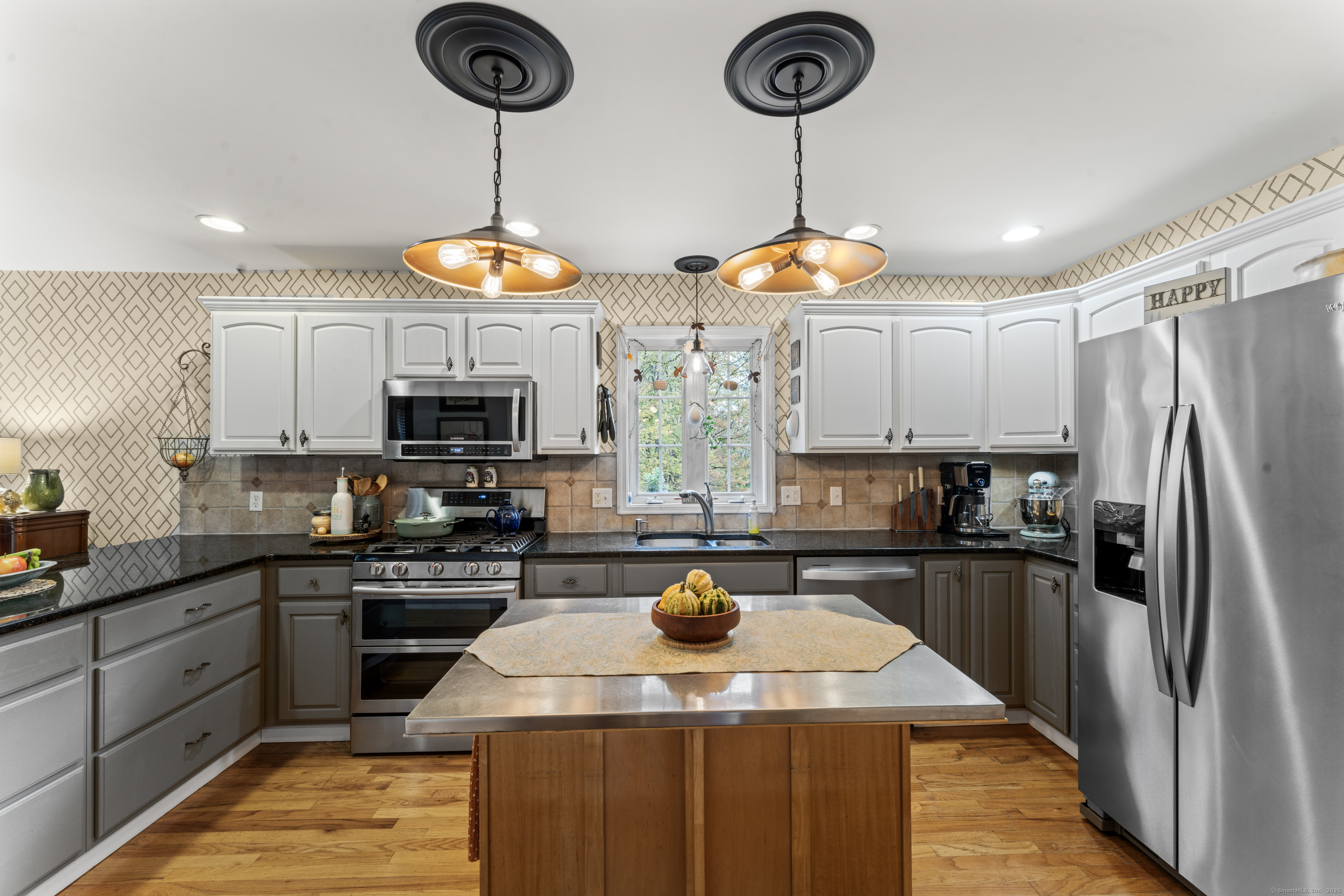 22 Lincoln Road Newtown, CT 06470 - Photo 15 of 36 a kitchen with stainless steel appliances granite countertop a sink a stove a refrigerator cabinets and chairs